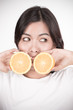 © Nonwarit - Young woman holding fresh oranges. Healthy eating. Isolated over