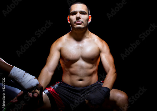 Latin MMA fighter or Boxer with trainer applying athletic tape Fototapet