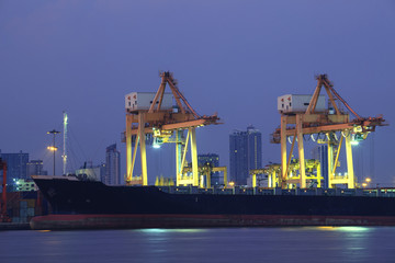 beautiful of container ship in port with lighting and dusky sky