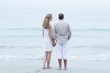 © WavebreakmediaMicro - Happy couple standing by the sea and holding hands