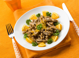 Wall Mural - meat stew with orange sauce and orange peel