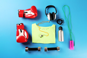 Poster - Sports equipment and T-shirt on color table, top view