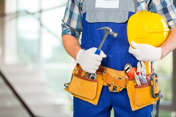 Wall Mural - Handyman. Handyman with a tool belt. Isolated on white