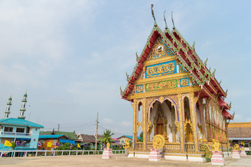 Wall Mural - Temple under sunlight and clear sky at Wat Khok Chindaram