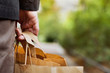 © Song_about_summer - consumer basket, close up of paper shopping bags in male hand
