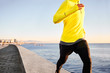 © wayhome.studio  - Jogging athlete man running at sun sunset beach in Barcelona cit