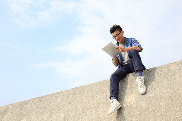 Wall Mural - Happy man using digital tablet