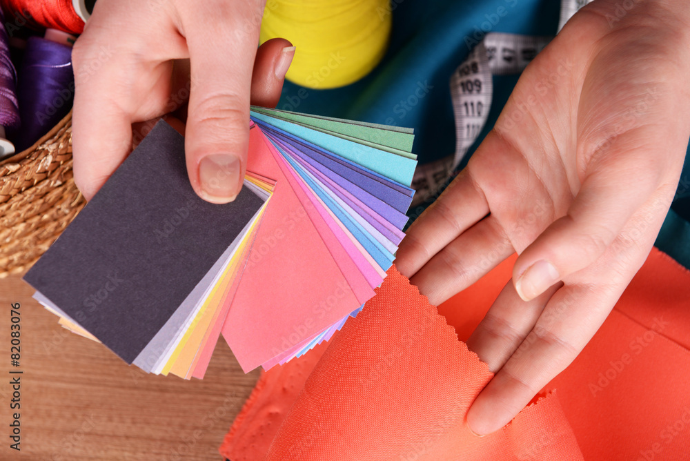 Samples of colorful fabric in female hands, closeup
