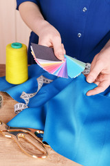 Wall Mural - Samples of colorful fabric in female hands, closeup