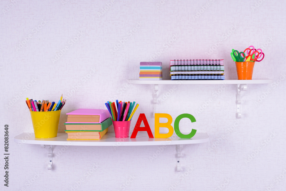 Shelves with stationery in child room close-up