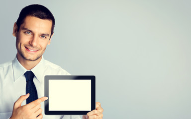 Wall Mural - Young businessman showing blank tablet pc