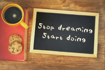 Wall Mural - top view image of blackboard with the phrase stop dreaming start