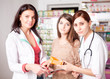 © DC Studio - Two doctors and one client inside pharmacy
