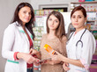 © DC Studio - Two doctors and one client inside pharmacy