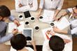 © Africa Studio - Group of business people working at desk top view
