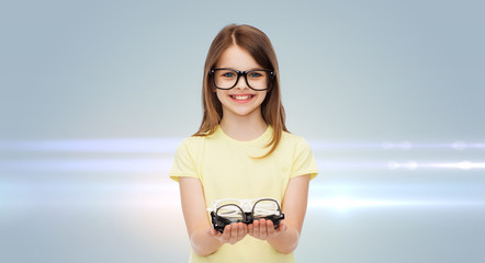 Canvas Print - smiling cute little girl in black eyeglasses