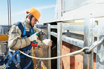 Worker builder at facade installation work