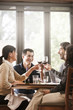 © John Fedele/Blend Images - Friends drinking red wine together in restaurant