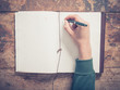 © LoloStock - Male hand writing in notepad