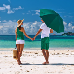 Couple in green on a beach at Seychelles