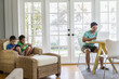 © Inti St Clair/Blend Images - Hispanic family relaxing in living room