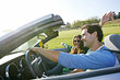 © Peathegee Inc/Blend Images - Couple driving in convertible