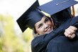 © Andres Rodriguez/Blend Images - Graduating Hispanic couple in cap and gown hugging
