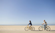 © PBNJ Productions/Blend Images - Couple riding bicycles on beach