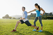 © Peathegee Inc/Blend Images - Couple stretching in park