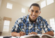 © Mike Kemp/Blend Images - Smiling Hispanic man studying