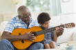 © JGI/Tom Grill/Blend Images - Boy playing guitar with grandfather