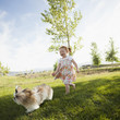 © Mike Kemp/Blend Images - Caucasian girl chasing dog in grass
