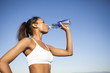 © Take A Pix Media/Blend Images - Mixed race woman drinking water bottle