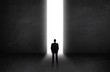 © ra2 studio - Business person looking at wall with light tunnel opening