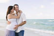 © PBNJ Productions/Blend Images - Caucasian man hugging pregnant wife on beach