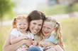 © Mike Kemp/Blend Images - Caucasian mother and daughters smiling outdoors