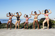 © Granger Wootz/Blend Images - Women flexing muscles on beach