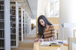 © John Fedele/Blend Images - Student working at desk in library