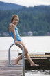 © Don Mason/Blend Images - Asian girl jumping off dock