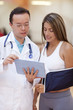 © Andres Rodriguez/Blend Images - Hispanic doctor and patient using tablet computer