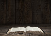 Bible. Image Of An Old Holy Bible On Wooden Background In A Dark