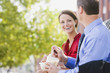 © John Fedele/Blend Images - Caucasian co-workers having lunch together outdoors