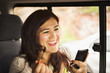 © Sollina Images/Blend Images - Hispanic woman using cell phone in car
