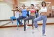© Andres Rodriguez/Blend Images - Hispanic women taking exercise class in gym