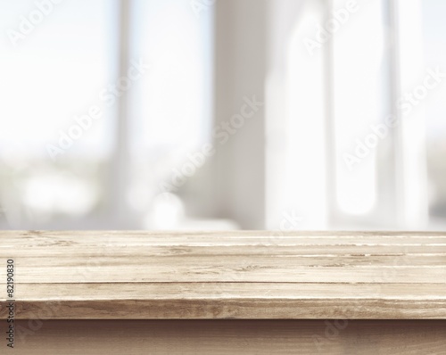 Background. Wooden table on defocuced window with curtain Poster