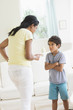 © JGI/Tom Grill/Blend Images - Mother scolding son in living room