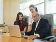 © Erik Isakson/Blend Images - Business people working on laptop