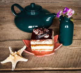 set of colorful cups and dishes and dessert