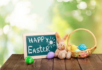 Wall Mural - Easter. Painted Easter eggs in a basket on the table with a