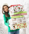 © Mike Kemp/Blend Images - Caucasian woman holding Christmas gifts in snow
